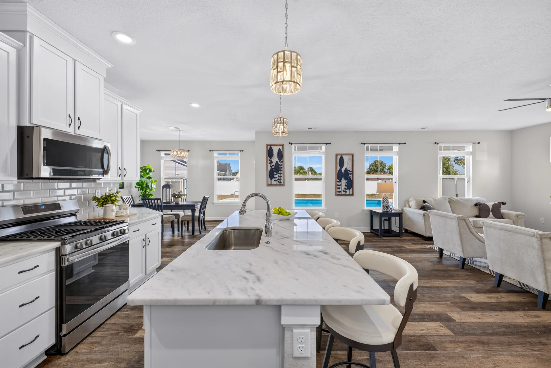White kitchen island opening onto the dining and living areas